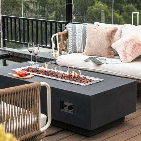 Elementi Granville Fire Pit Table in Dark Gray outdoor with trees