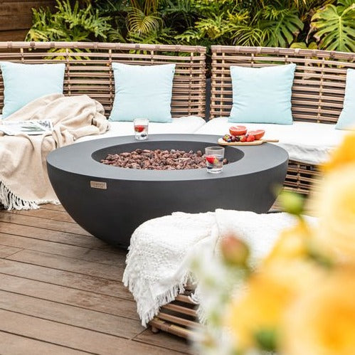 Elementi Lunar Bowl Fire Pit Table - Dark Gray in a Porch with Flowers