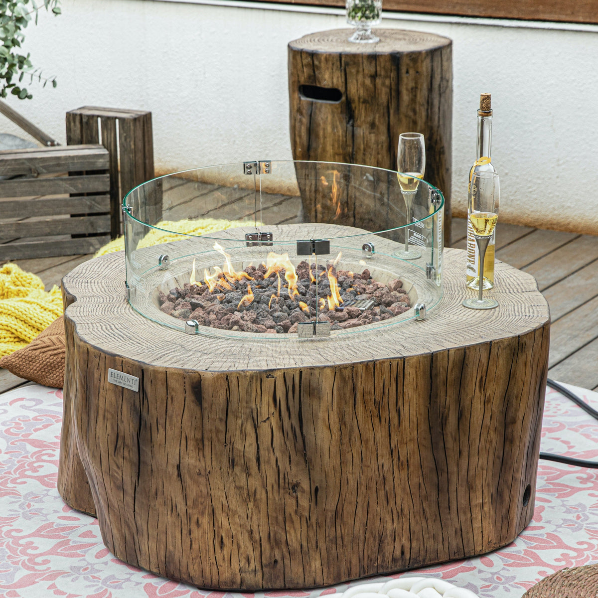 Elementi Manchester Fire Pit Table in Red Wood outdoor with windscreen