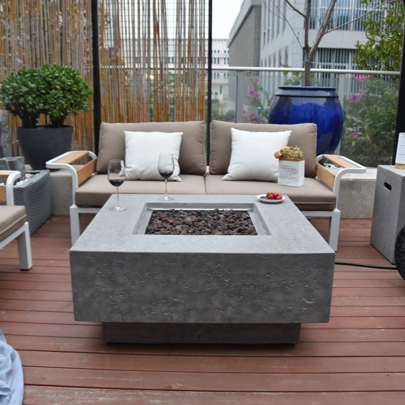 Elementi Manhattan Fire Pit Table in Light Gray in a porch