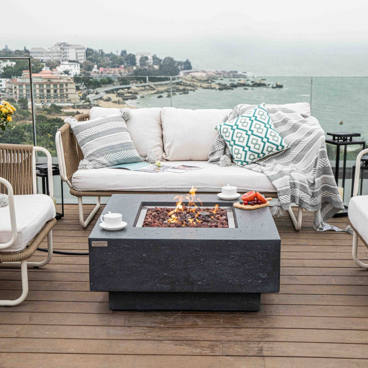 Elementi Manhattan Fire Pit Table in Dark Gray in a porch with view
