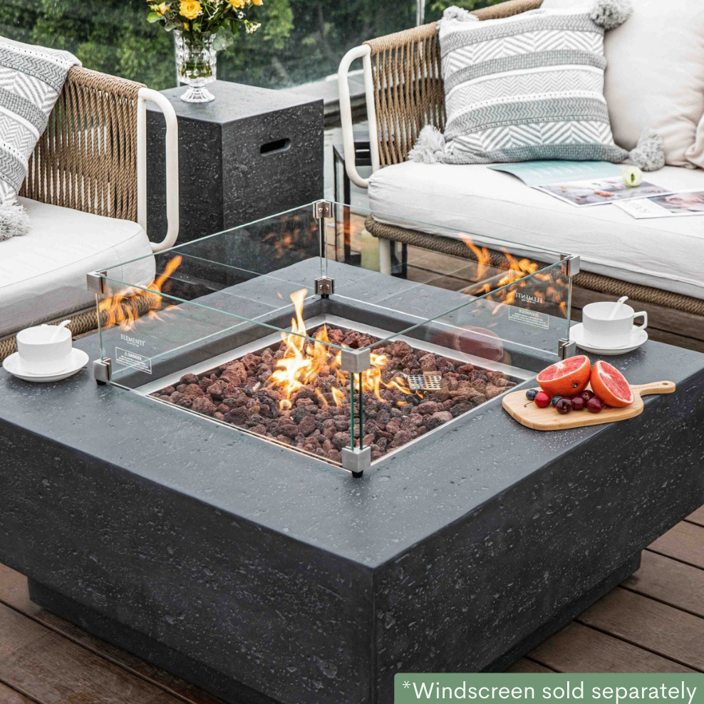 Elementi Manhattan Fire Pit Table in Dark Gray with wind screen lit outdoor